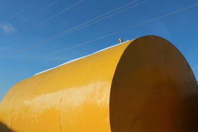 Low angle view of power lines against blue sky