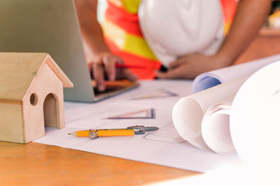 Close-up of worker working on table