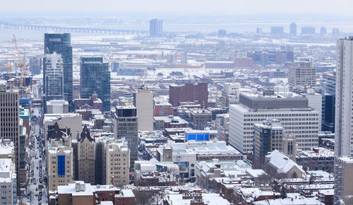 High angle view of buildings in city against sky