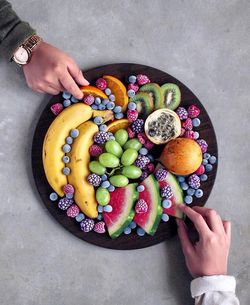 High angle view of woman holding fruits