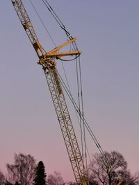 Low angle view of crane against clear sky