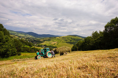 Tractor on field against sky