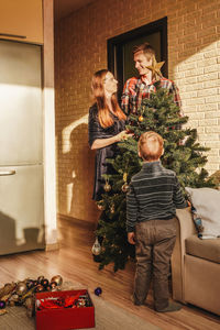 Portrait of smiling family sitting on sofa at home