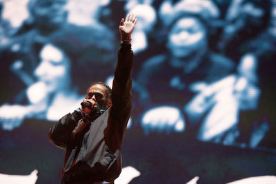 Full length of man with arms outstretched standing outdoors