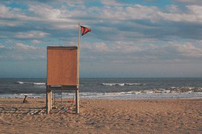 Lifeguard hut on beach against sky