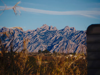Scenic view of mountains against blue sky