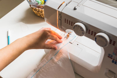 Woman's hands using sewing scissors