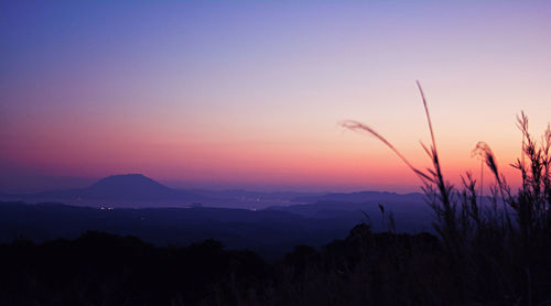 Scenic view of silhouette mountains against sky at sunset