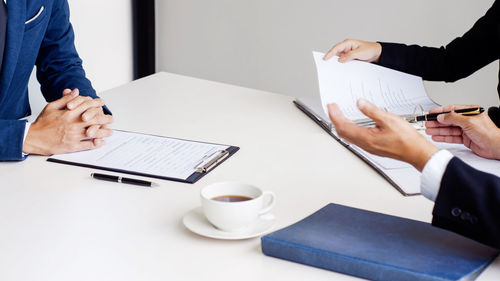 Midsection of woman using laptop on table