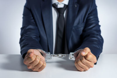 Close-up of hands over white background