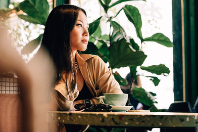 Young woman holding coffee cup