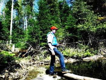 Full length of man standing in forest