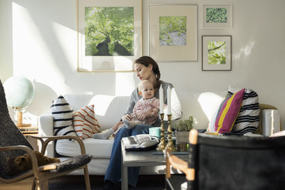 Woman sitting on table at home