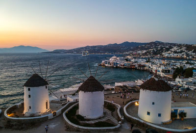 High angle view of townscape by sea against sky