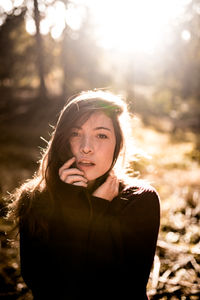 Portrait of beautiful young woman standing on land