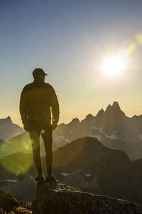 Silhouetted view of hiker on mountain summit exploring scenic area