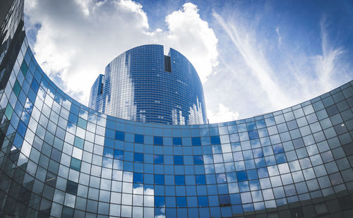 Low angle view of modern building against blue sky