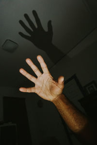 Cropped hand of man in darkroom