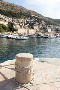 Boats moored at harbor by buildings in town