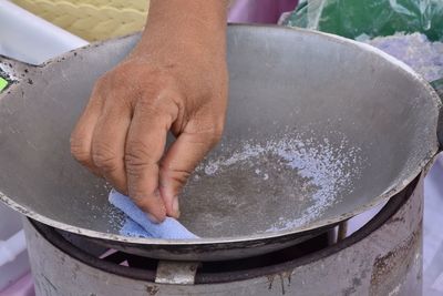 Cropped hand of man preparing food at market