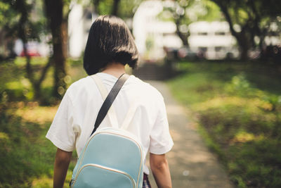 Rear view of woman walking in park