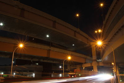 Illuminated light trails on road at night