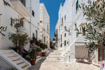 Alley amidst buildings in city against sky