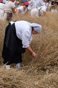 Rear view of man and woman on field