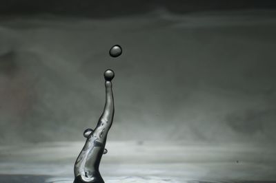 Close-up of water drop falling on wet wall