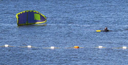 High angle view of people floating in sea