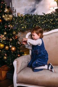 Little child at home for christmas with gifts