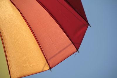 Low angle view of umbrella against clear sky