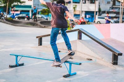 Full length of man skateboarding on skateboard in city