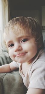 Close-up portrait of cute boy at home