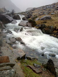 Scenic view of waterfall against sky