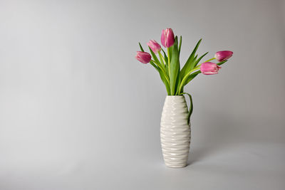 Close-up of pink flower vase on table