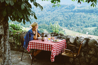 Woman relaxing on chair at table