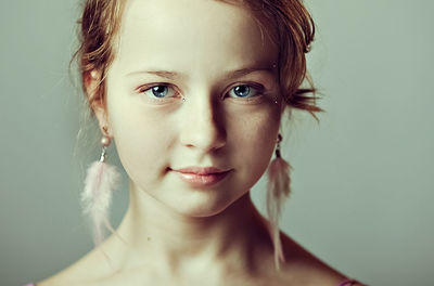  portrait of a young girl with festive makeup for a party.earrings-feathers in the ears