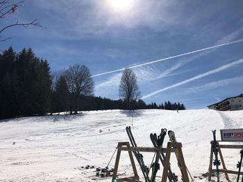 Scenic view of snowcapped field against sky