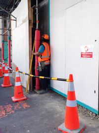 Manual worker with traffic cones at construction site