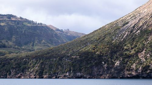 Scenic view of mountains and sea against sky