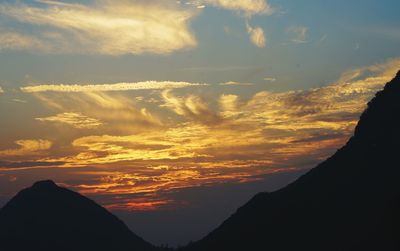 Scenic view of silhouette mountains against sky during sunset