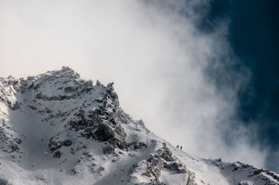 Scenic view of snow covered mountains against sky