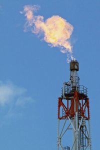 Low angle view of flame stack against sky