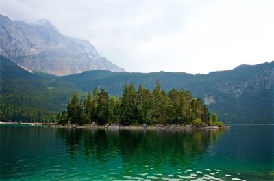 Scenic view of lake and mountains against sky