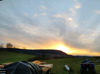 Scenic view of field against sky during sunset