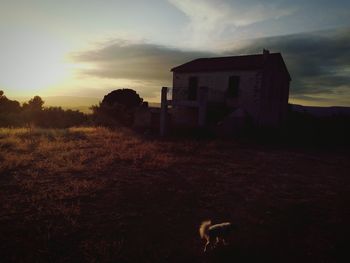 Buildings in a field against sky