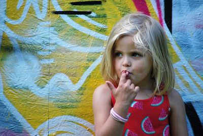 Girl against graffiti wall