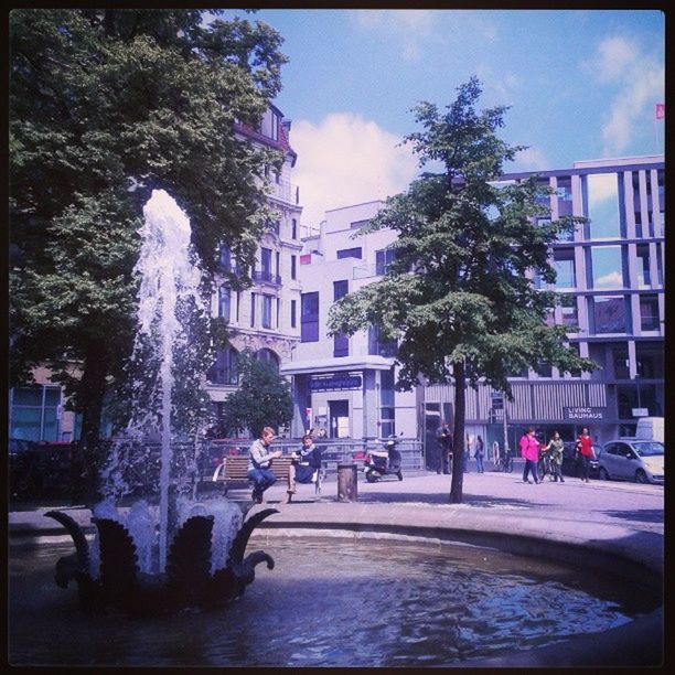 building exterior, architecture, built structure, transfer print, city, tree, auto post production filter, sky, building, fountain, water, incidental people, city life, street, men, residential building, day, person, outdoors