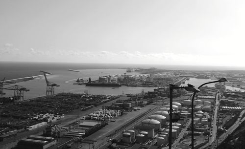 High angle view of cityscape by sea against sky